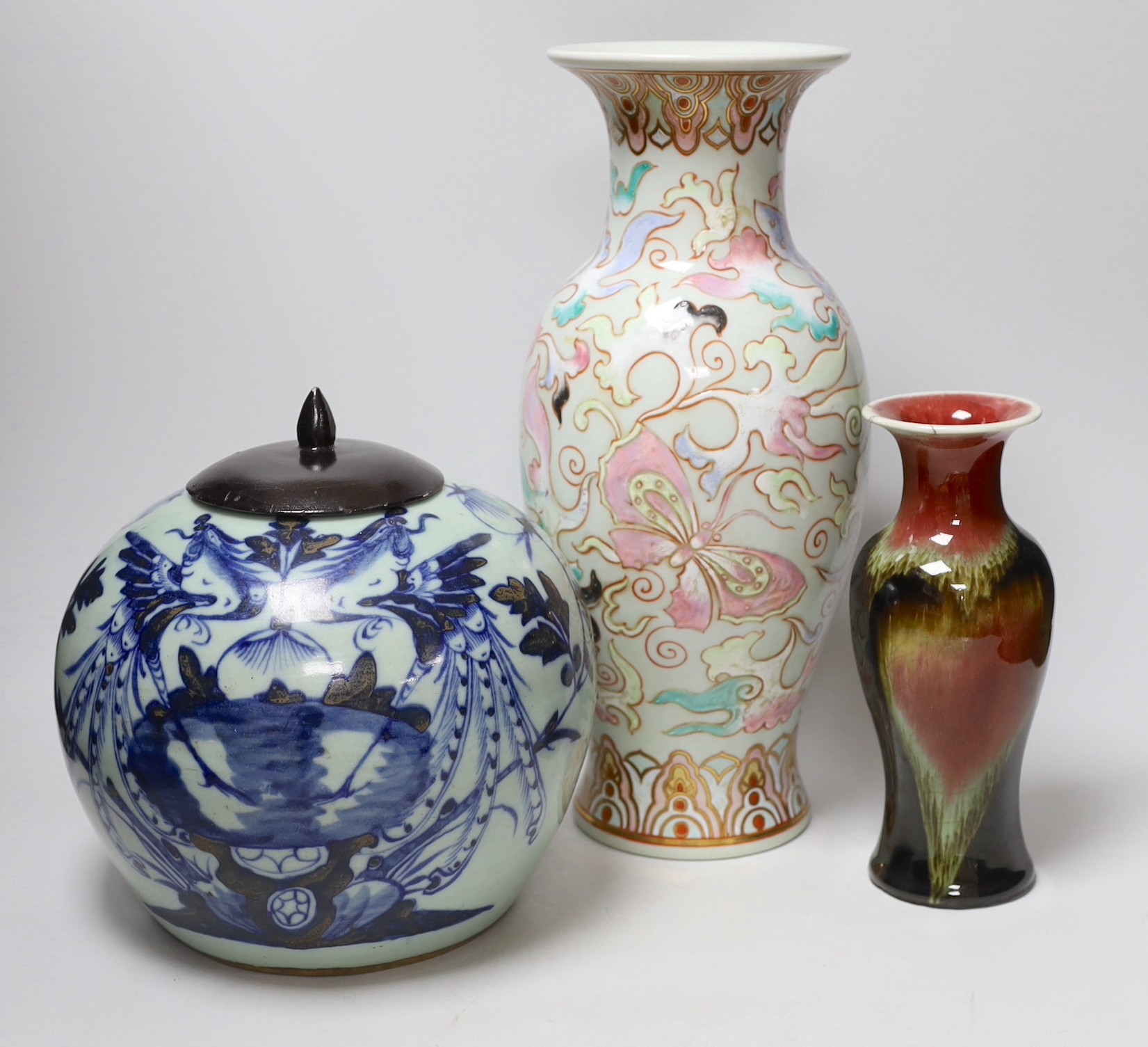 A Chinese blue and white celadon ground jar an enamelled porcelain vase and a flambe vase, tallest 42cms high (3)